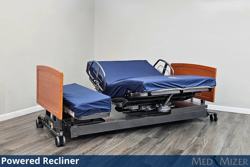Powered recliner bed with wooden sides and blue mattress in a room setting.