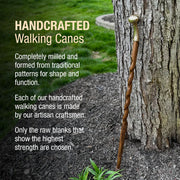 Handcrafted walking cane leaning against a tree with promotional text about traditional craftsmanship.