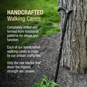 Handcrafted walking cane leaning against a tree with promotional text about craftsmanship.