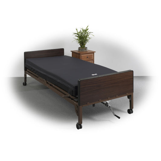 Medical bed with dark wooden frame and black mattress on a white background