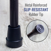 Black cane with slip-resistant rubber tip on a light wood background