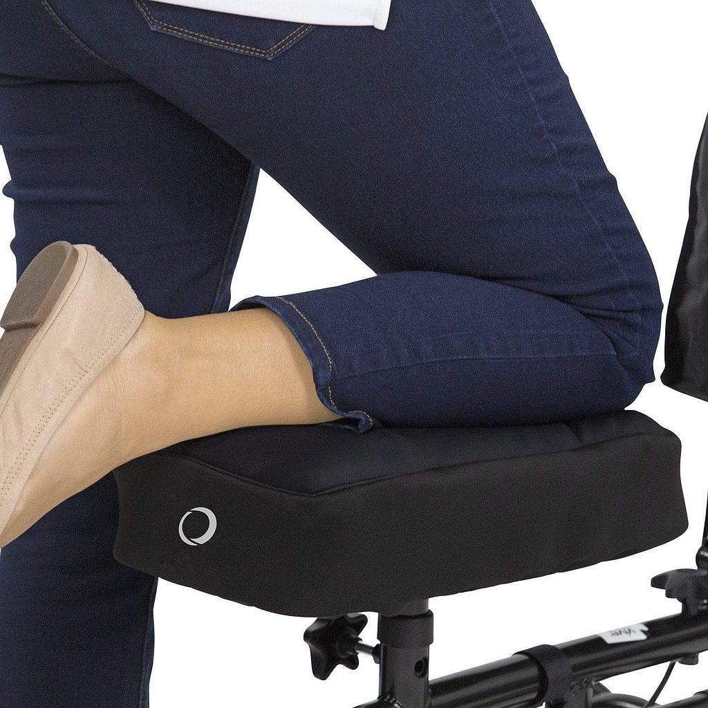 Person sitting on a black office chair with a close-up of their foot wearing a tan shoe.