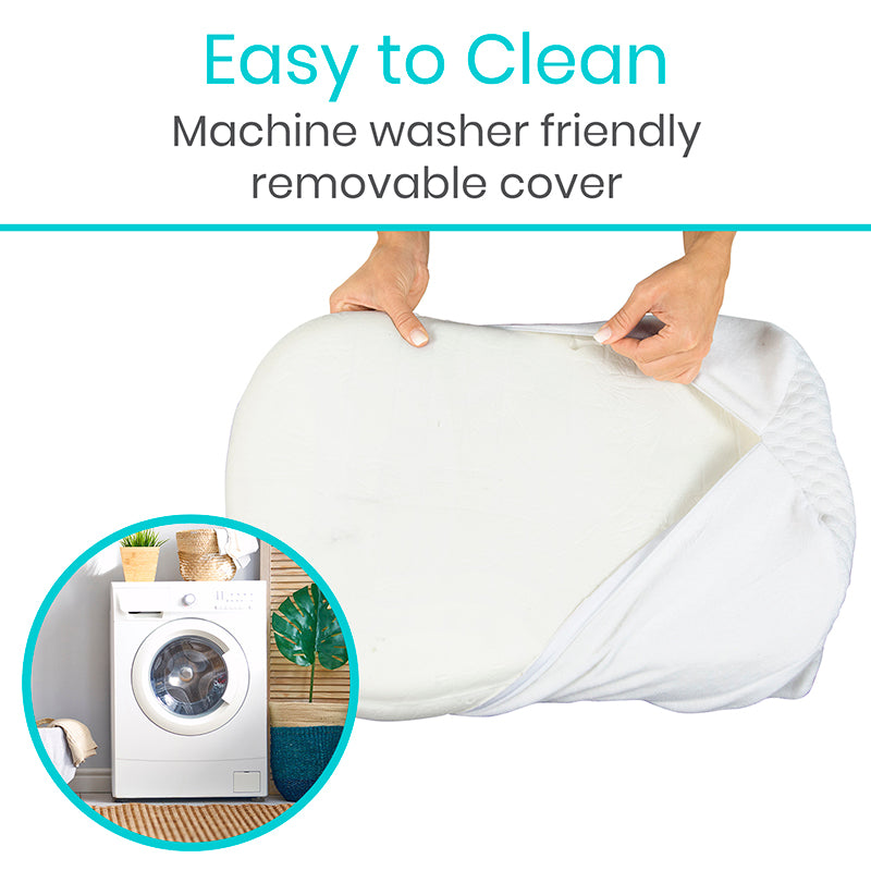 White pillow with a machine washer friendly removable cover, held by hands.