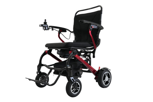 A compact electric wheelchair with a black seat and backrest, a red metal frame, and black wheels, shown from a three-quarter angle on a solid white background.