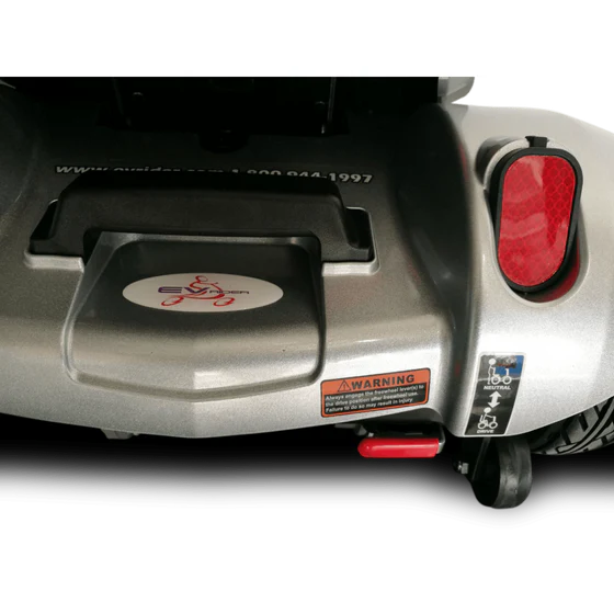 Close-up of a scooter with visible branding and warning labels on a white background