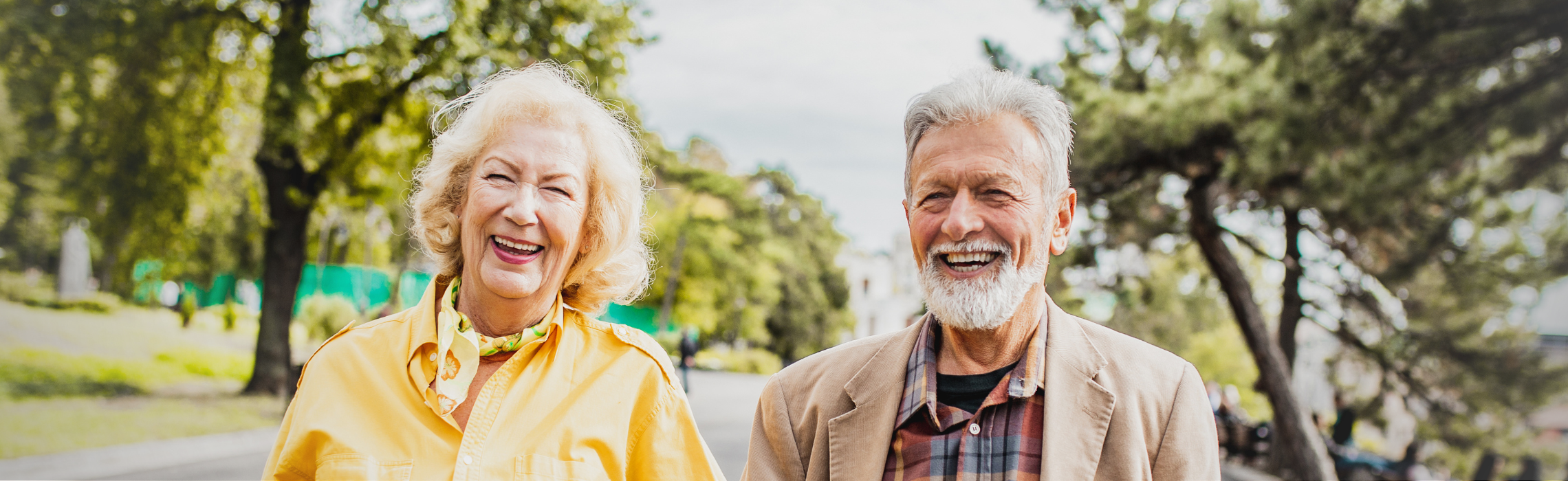 Senior couple walking outdoors in a park