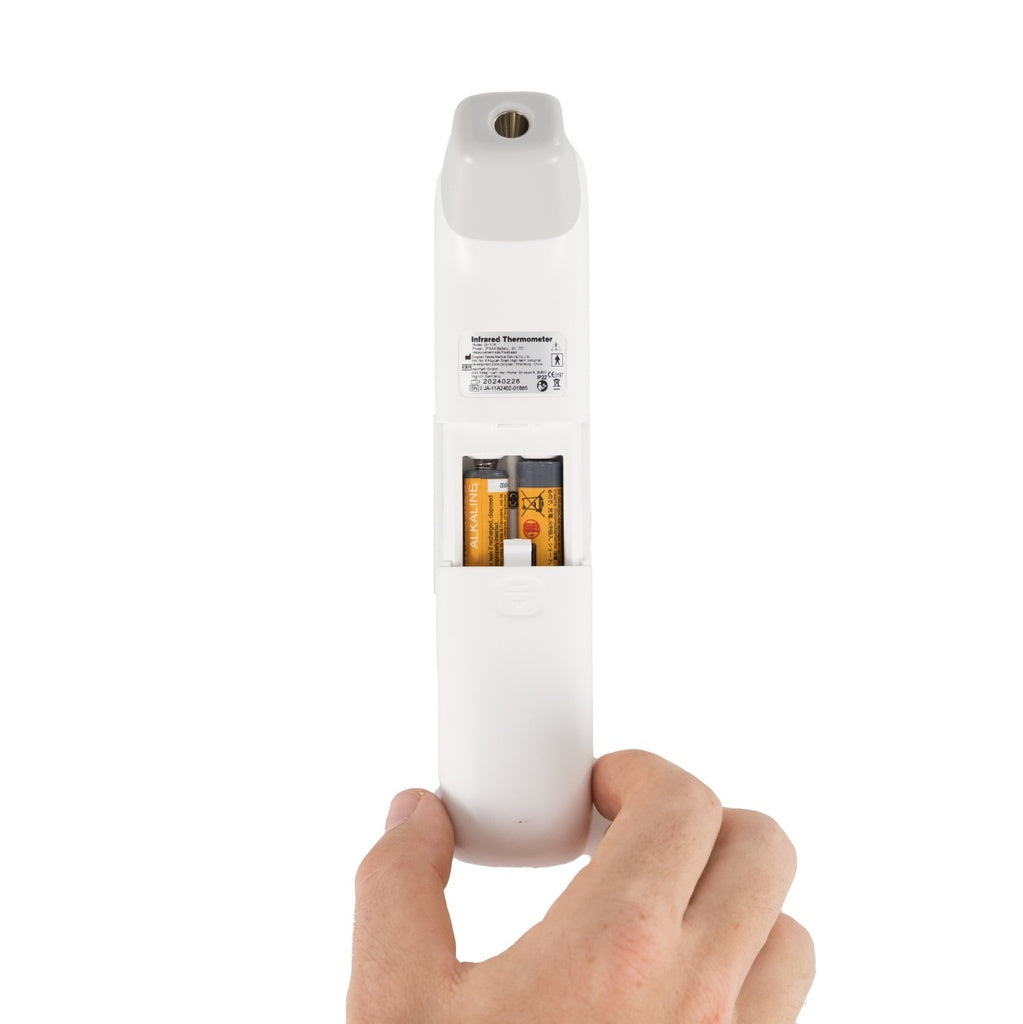 Hand holding a white cylindrical product with a label on a white background
