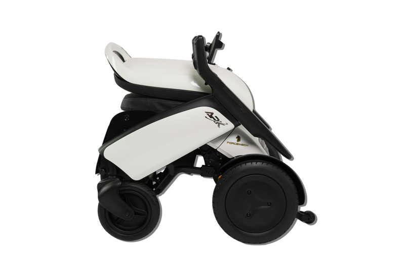 A compact electric wheelchair shown from a side profile view against a solid white background. The wheelchair features a white body shell with black accents, a black seat, and large black wheels.
