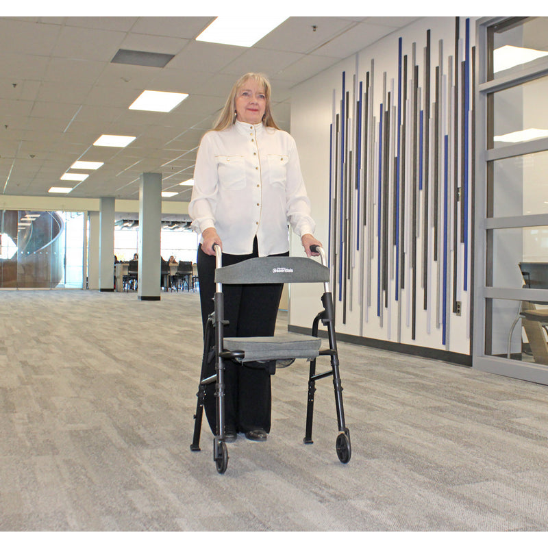 Woman pushing a walker in an indoor setting with a modern design.