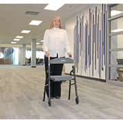 Woman pushing a walker in an indoor setting with a modern design.