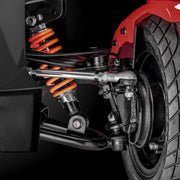 Close-up of a motorcycle suspension system with orange springs on a black background