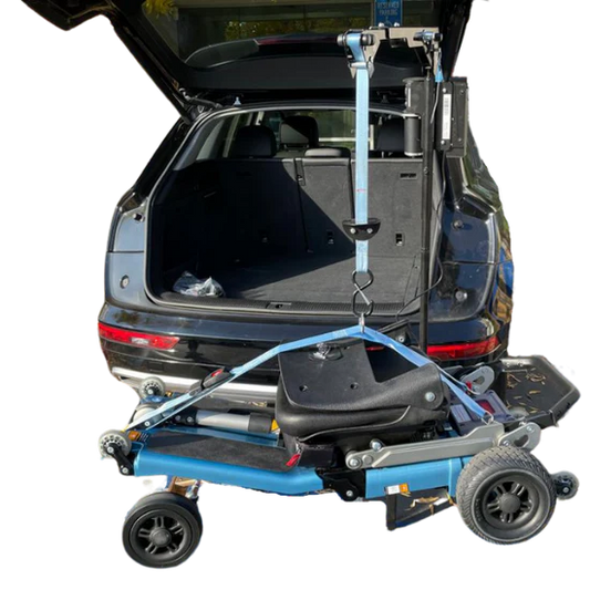 Blue and black vehicle ramp attached to a car with open trunk on a white background