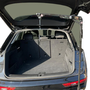 Open trunk of a car with a roof rack on a white background