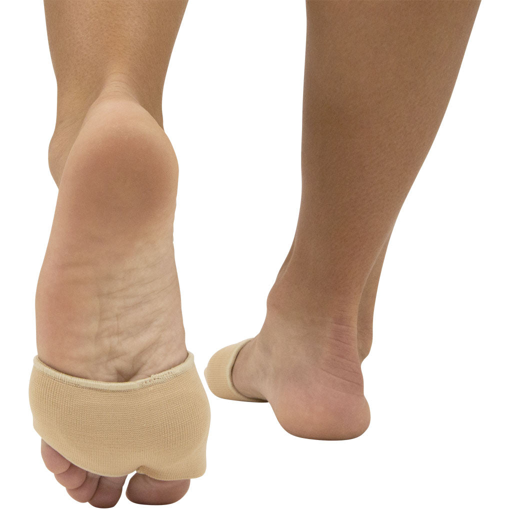 Beige compression socks being worn on a person's legs with a white background