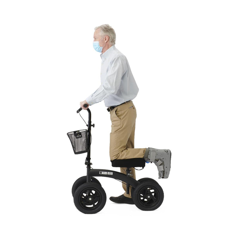 Man using a knee walker on a white background