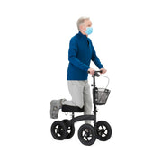 Person using a knee walker with a basket on a white background