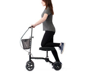Person using a knee walker on a white background