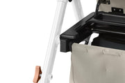 Close-up of a rollator with a beige cushion and white frame on a light gray background