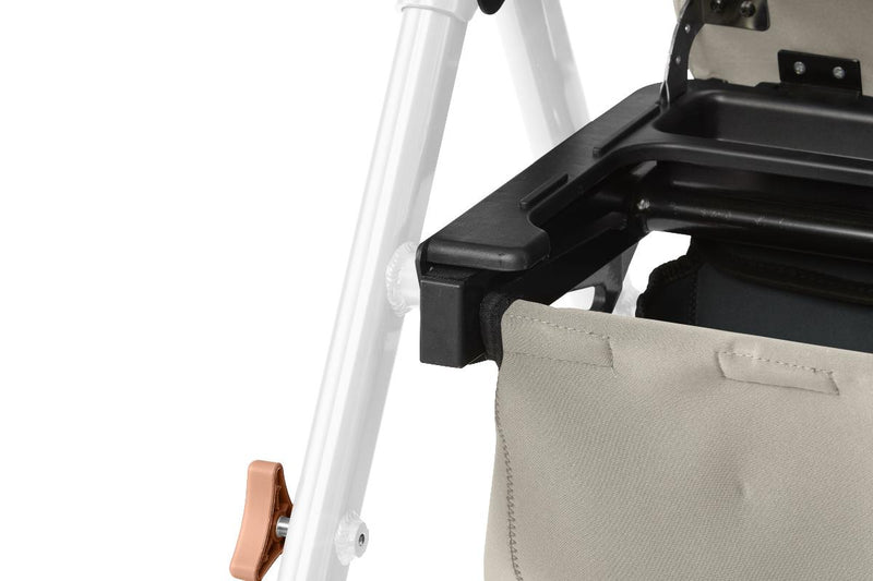 Close-up of a rollator with a beige cushion and white frame on a light gray background