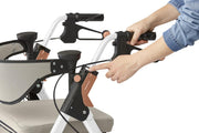 Close-up of a person adjusting controls on a rollator with a white background