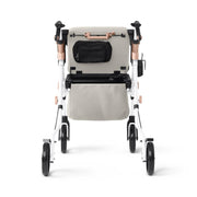 Beige and white rollator with a black bag on a white background