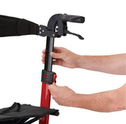 Close-up of a person's hands adjusting a black and red wheeled frame component on a white background.