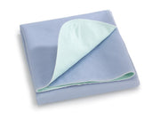 Folded blue underpad with a light green corner on a white background