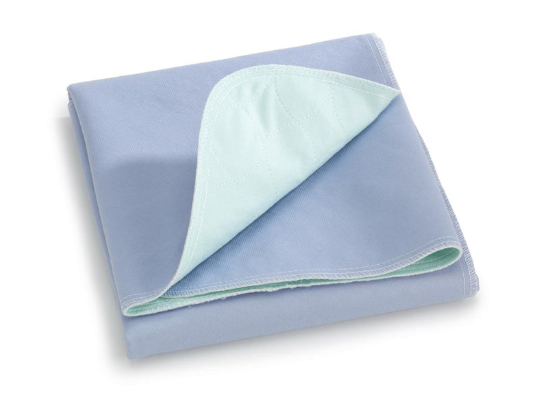 Folded blue underpad with a light green corner on a white background