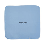 Light blue pad with 'THIS SIDE DOWN' text on a white background