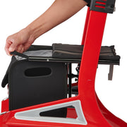 Red exercise bike with a person adjusting the seat