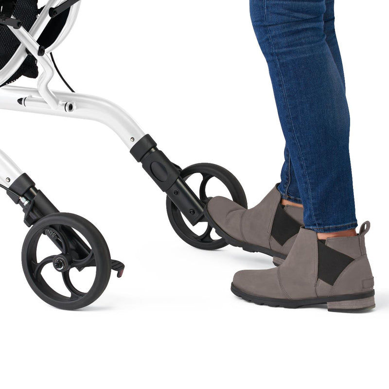 Person wearing brown boots stepping onto a stroller with a white background