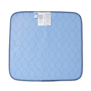 A light blue quilted underpad with a dark blue stitched border and two white product tags attached near the top edge, shown on a plain white background.