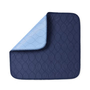 A navy blue quilted underpad with a light blue reverse side, shown on a plain white background.