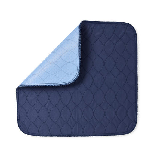 A navy blue quilted underpad with a light blue reverse side, shown on a plain white background.
