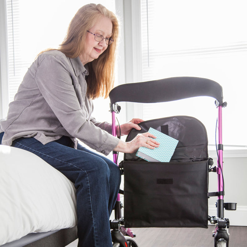 woman putting items in her rollator bag