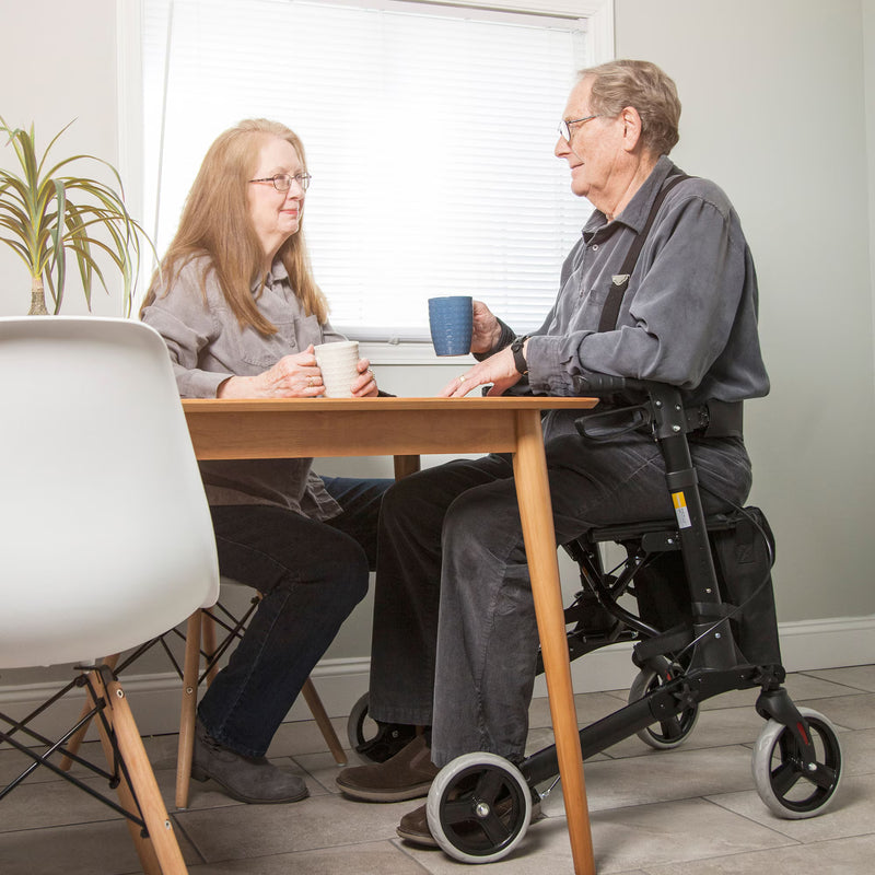 man sitting at table with his rollator 