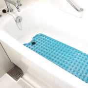 Blue bath mat with bubble design on a bathtub