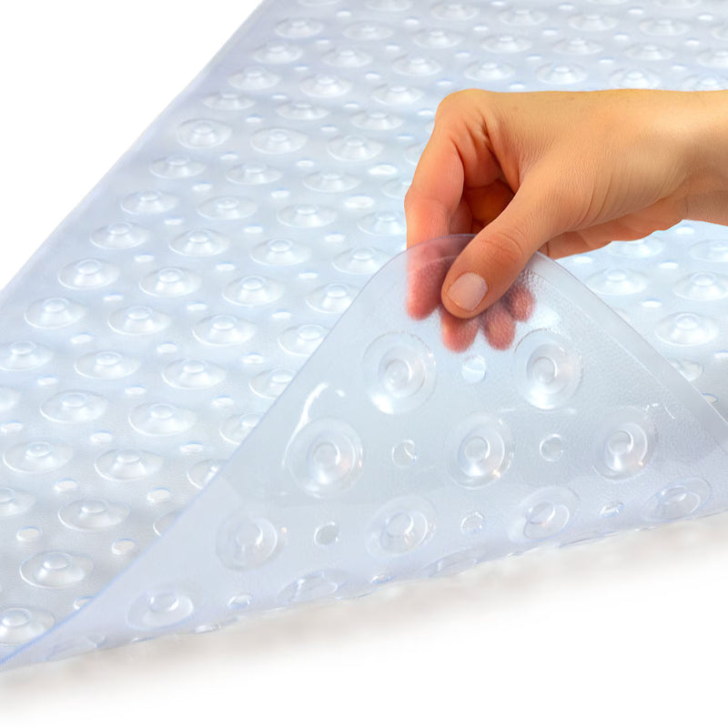 Hand holding a clear bubble wrap sheet over a white surface