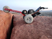 All-terrain vehicle on a rocky cliff edge with ocean view