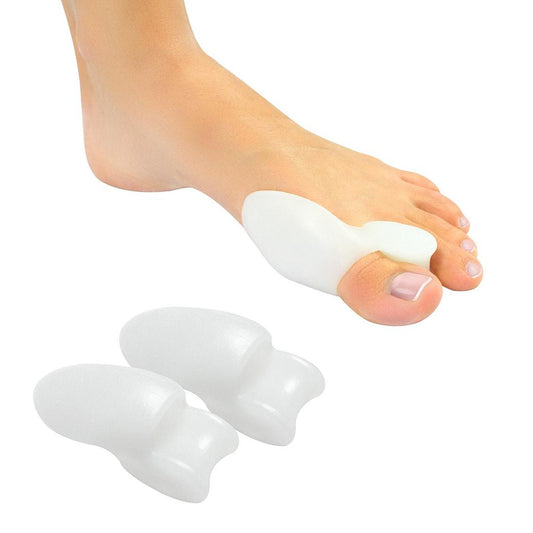White bunion correctors on a foot with a white background