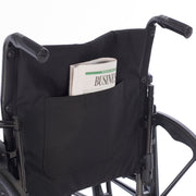 Wheelchair with a black pocket holding a newspaper on a white background