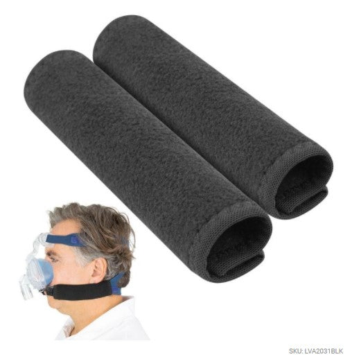 Two black foam pillows for a CPAP mask on a white background with a person wearing a CPAP mask.
