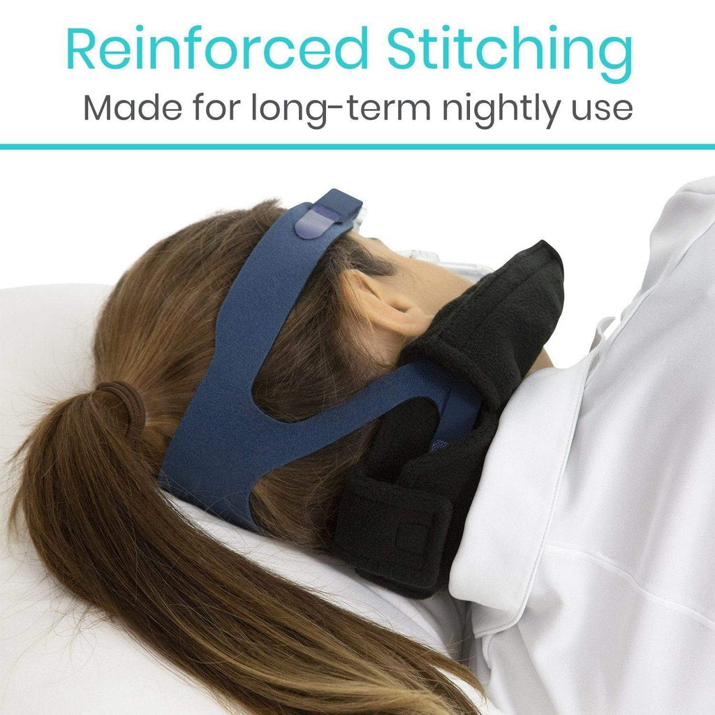 Person wearing a blue sleep mask with text about reinforced stitching for long-term use.
