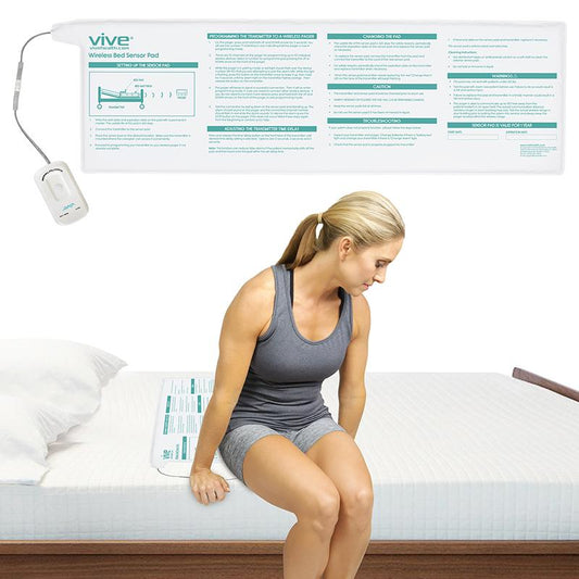 Woman using a Vive wireless bedwetting device pad on a bed.