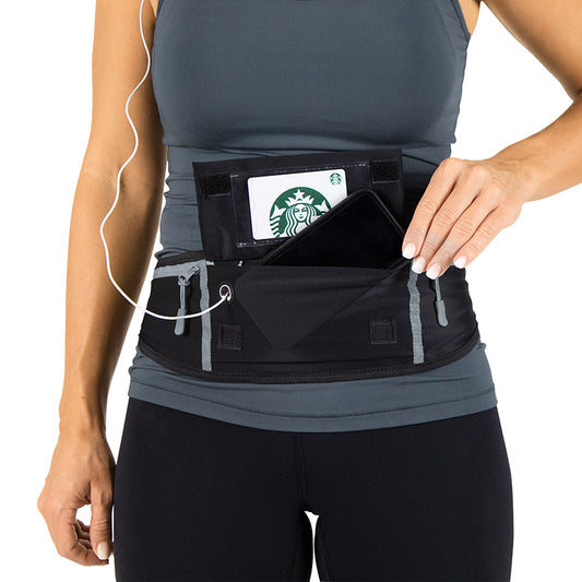 Person wearing a black waist pouch with a Starbucks card on a white background