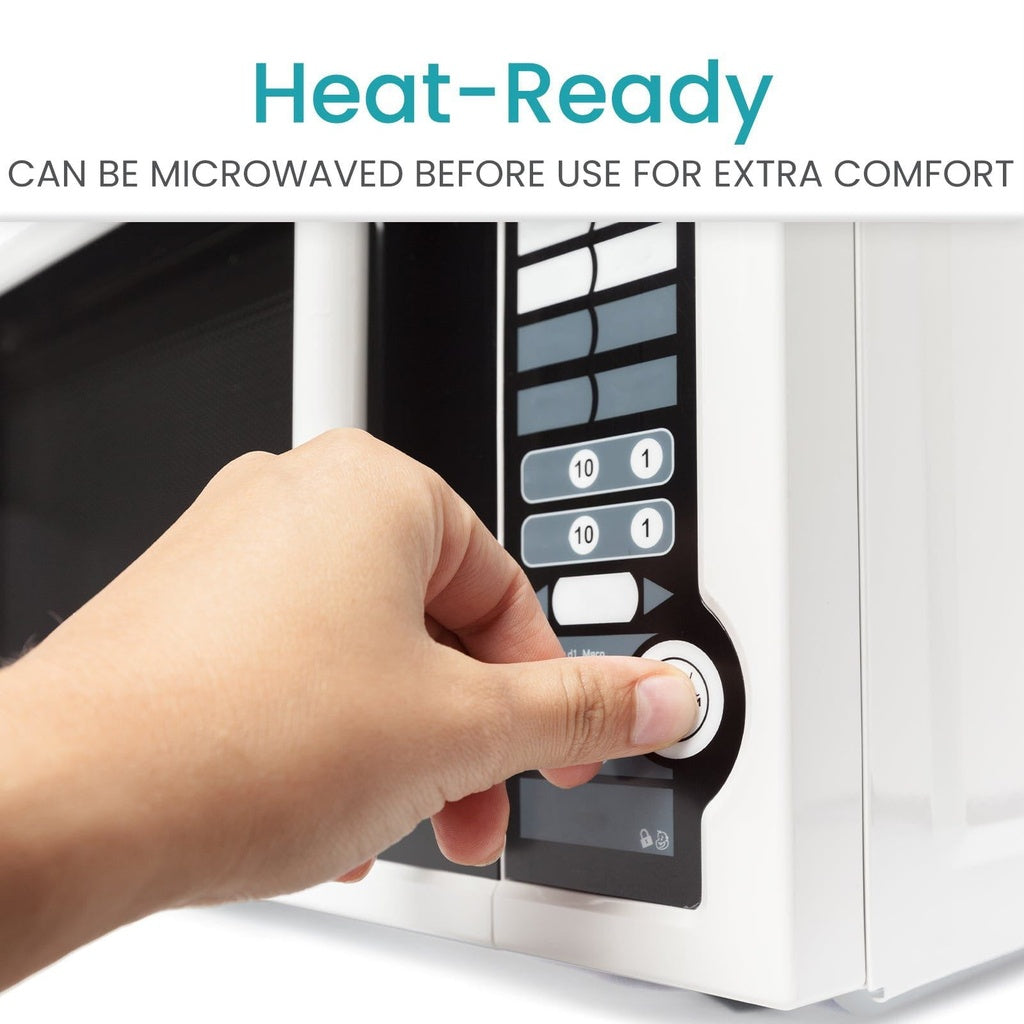 Hand pressing a button on a microwave with text indicating it can be microwaved before use.