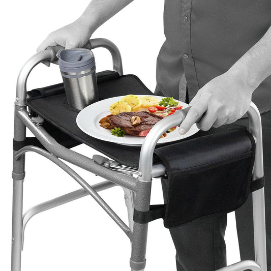 Person using a walker with an attached tray holding a plate of food and a cup.