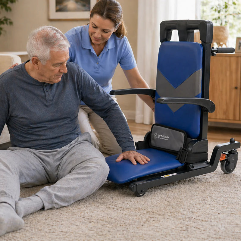 Man using a blue and black lift chair with a caregiver assisting him in a home setting.