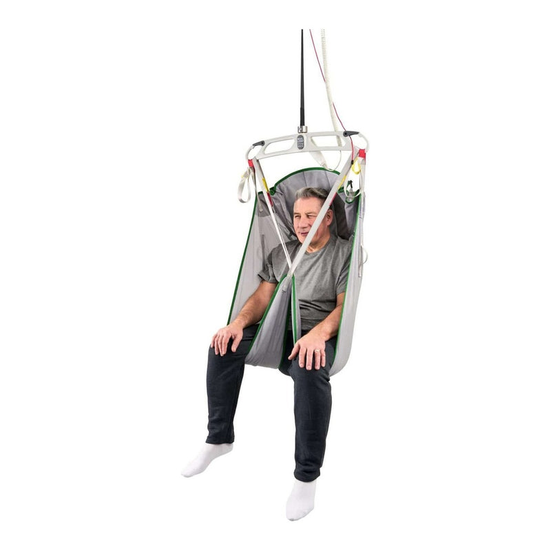 A man sitting in a suspended mesh chair with a white frame and green trim, shown against a plain white background.