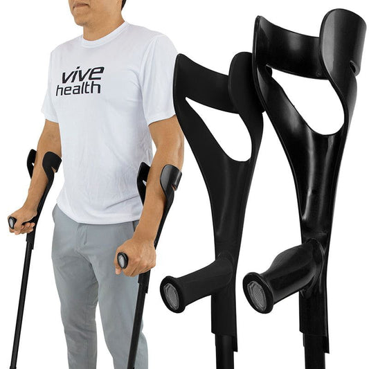 Person using black crutches with 'vive health' t-shirt on a white background